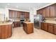 Spacious kitchen featuring an island, stainless steel appliances, and granite countertops at 2588 Gabrielle Woods Pl, Oviedo, FL 32765