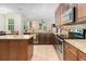 Gourmet kitchen with an island, stainless steel appliances, and granite countertops at 2588 Gabrielle Woods Pl, Oviedo, FL 32765