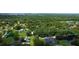 Aerial view showcasing property boundaries, lush greenery, pool, and a serene pond at 2623 8Th St, Orlando, FL 32820
