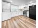 Modern kitchen with white cabinetry, stainless steel appliances, and a washer-dryer unit at 2623 8Th St, Orlando, FL 32820