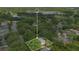 Aerial view of a home nestled among mature trees, highlighting its proximity to a serene lake at 2794 Cullens Ct, Ocoee, FL 34761