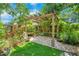 Beautiful backyard with a pergola, brick patio, artificial grass, and serene setting at 2794 Cullens Ct, Ocoee, FL 34761