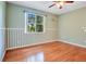A bedroom features wood floors, light green walls, one window and overhead ceiling fan at 2794 Cullens Ct, Ocoee, FL 34761