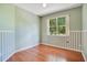 Charming bedroom with light green walls, decorative wainscoting, and hardwood floors at 2794 Cullens Ct, Ocoee, FL 34761
