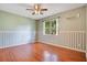 A bedroom features wood floors, light green walls, one window and overhead ceiling fan at 2794 Cullens Ct, Ocoee, FL 34761
