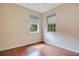 A bright bedroom features hardwood floors and dual windows, inviting natural light at 2794 Cullens Ct, Ocoee, FL 34761
