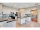 A kitchen featuring white cabinets, stainless steel appliances, tile flooring, and an island at 2794 Cullens Ct, Ocoee, FL 34761