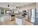 A kitchen features white cabinets, stainless steel appliances, tile flooring, and an island at 2794 Cullens Ct, Ocoee, FL 34761