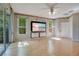 Living room featuring light wood floors, many windows, and built-in tv at 2794 Cullens Ct, Ocoee, FL 34761