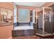 Main bathroom showcasing a jacuzzi bathtub and glass shower at 2794 Cullens Ct, Ocoee, FL 34761