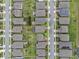 An overhead shot of rooftops in an organized neighborhood, with well-manicured lawns and streets at 2929 Bluestem Ln, Clermont, FL 34714