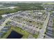 Overhead view of a well-maintained neighborhood, featuring scenic ponds and lush landscaping at 2929 Bluestem Ln, Clermont, FL 34714