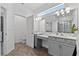 Bright bathroom with dual vanities and an expansive mirror that reflects the shower at 2929 Bluestem Ln, Clermont, FL 34714