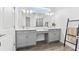 Elegant bathroom with dual sinks, gray cabinetry, and an oversized mirror at 2929 Bluestem Ln, Clermont, FL 34714
