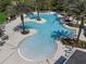 Aerial view of a large, modern community pool area with palm trees and plenty of seating for residents at 2929 Bluestem Ln, Clermont, FL 34714
