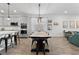 Open-concept dining room with a large wooden table, seating for six, and a view of the kitchen and living room at 2929 Bluestem Ln, Clermont, FL 34714