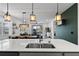 Open-concept kitchen with bar seating and a view to the dining area and living room at 2929 Bluestem Ln, Clermont, FL 34714