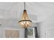 Elegant, beaded chandelier illuminating a space with neutral tones and a decorative wall hanging at 2929 Bluestem Ln, Clermont, FL 34714