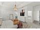Well-lit main bedroom with an ornate light fixture, and access to the closet and bathroom at 2929 Bluestem Ln, Clermont, FL 34714