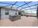 Outdoor patio with brick pavers, a spa, and a screened enclosure at 2929 Bluestem Ln, Clermont, FL 34714