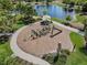 Aerial view of a new playground and splash pad, situated near a pond at 2929 Bluestem Ln, Clermont, FL 34714