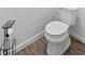 Close-up of a white toilet with a nearby black toilet paper holder at 2929 Bluestem Ln, Clermont, FL 34714