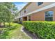Well-manicured backyard featuring a green lawn and privacy bushes at 3256 Rodrick Cir, Orlando, FL 32824