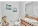Half bathroom featuring granite vanity, decorative mirror, and stylish decor at 3256 Rodrick Cir, Orlando, FL 32824