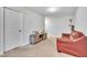 Bonus room showcasing neutral carpet, a leather sofa, and a closet at 3256 Rodrick Cir, Orlando, FL 32824