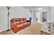 Carpeted bonus room featuring a leather sofa, neutral walls, and easy access to a full bath at 3256 Rodrick Cir, Orlando, FL 32824