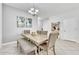 Open-concept dining room with modern chandelier, neutral decor, and tile floors at 3256 Rodrick Cir, Orlando, FL 32824