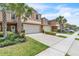 Charming townhome featuring a two-car garage, lush landscaping and curb appeal at 3256 Rodrick Cir, Orlando, FL 32824
