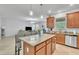 Open kitchen with granite countertops, stainless steel appliances, and seamless flow to living area at 3256 Rodrick Cir, Orlando, FL 32824