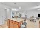 Kitchen island featuring granite countertops, seating, and a view of the living room area at 3256 Rodrick Cir, Orlando, FL 32824