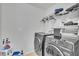 Functional laundry room with modern washer and dryer, shelving and well-lit at 3256 Rodrick Cir, Orlando, FL 32824