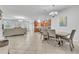 Open-concept living area with tile floors, neutral decor, and an adjacent modern kitchen at 3256 Rodrick Cir, Orlando, FL 32824
