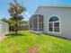 Spacious backyard with a screened lanai and green lawn at 3713 Becontree Pl, Oviedo, FL 32765