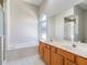 Bathroom featuring a double vanity, soaking tub, glass enclosed shower, and tile floors at 3713 Becontree Pl, Oviedo, FL 32765