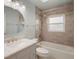 Updated bathroom features a shower-tub combo and a modern vanity with a marble countertop at 3713 Becontree Pl, Oviedo, FL 32765