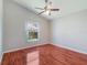 Bedroom featuring a ceiling fan, and a window looking out to some colorful flowers at 3713 Becontree Pl, Oviedo, FL 32765