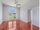 Bedroom with hardwood floors, a large window, and a ceiling fan at 3713 Becontree Pl, Oviedo, FL 32765