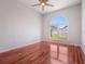 Bright bedroom featuring a ceiling fan, a large window, and hardwood floors at 3713 Becontree Pl, Oviedo, FL 32765