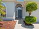 Close-up showcasing the arched entryway and the meticulously landscaped front yard at 3713 Becontree Pl, Oviedo, FL 32765