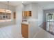 Kitchen with a breakfast bar, white counters, tile floors, and wood cabinets at 3713 Becontree Pl, Oviedo, FL 32765