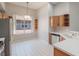 Bright kitchen with white tile floors, stainless steel appliances, and light wood cabinets at 3713 Becontree Pl, Oviedo, FL 32765
