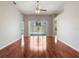 Spacious living room featuring gleaming hardwood floors and sliding glass doors to the patio at 3713 Becontree Pl, Oviedo, FL 32765