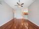 Expansive living room with wood floors that flows to the kitchen at 3713 Becontree Pl, Oviedo, FL 32765