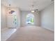 Living room with carpet, high ceilings, chandelier, and a ceiling fan at 3713 Becontree Pl, Oviedo, FL 32765