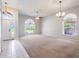 Expansive living room with carpet floors and large windows at 3713 Becontree Pl, Oviedo, FL 32765