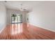 Living room with wood floors, a sliding glass door to the patio, and neutral walls at 3713 Becontree Pl, Oviedo, FL 32765